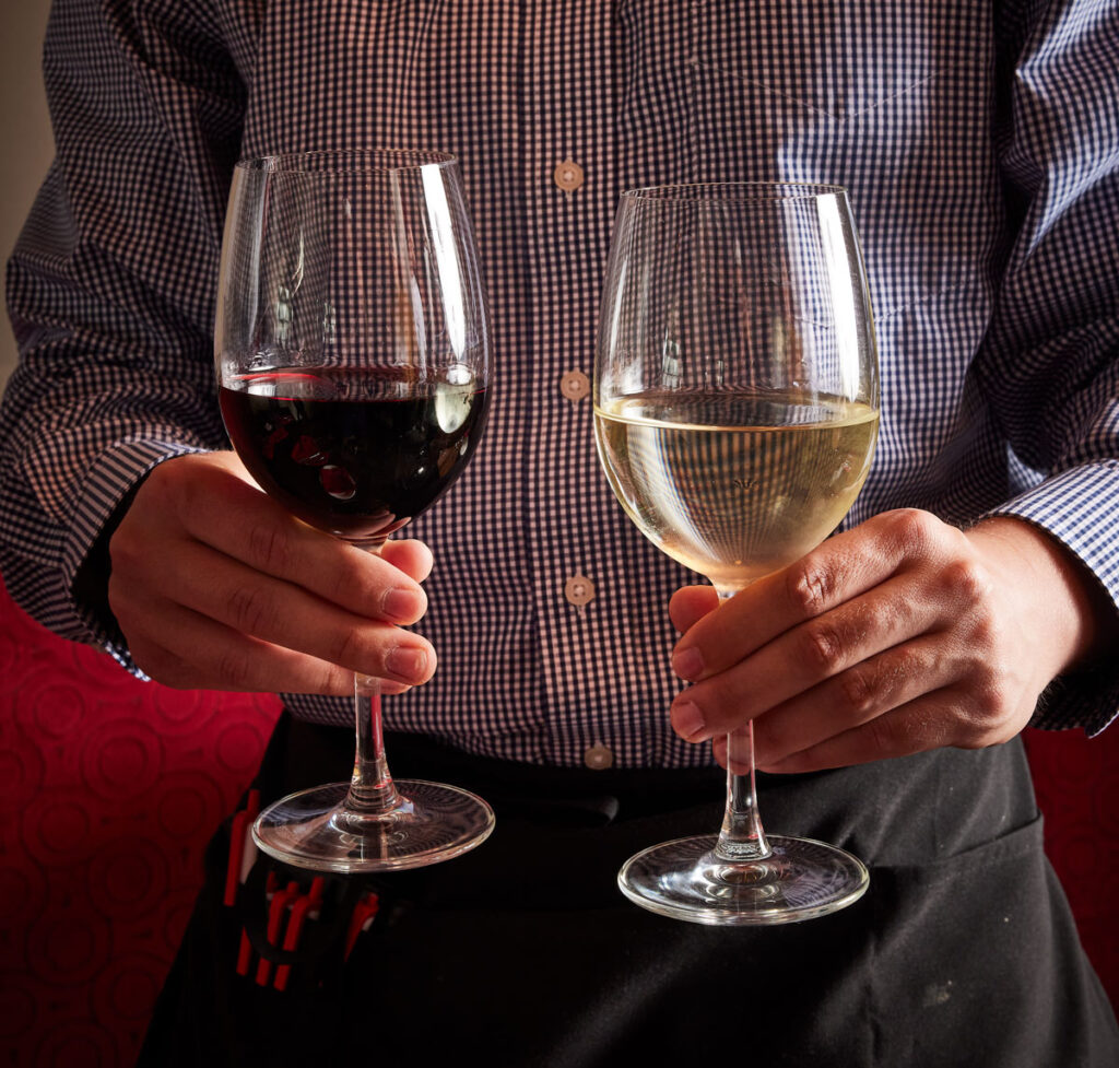 Man holding 2 glasses of wine